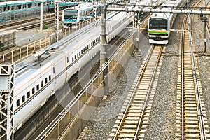 Industrial or mass transit background featuring detail of electrical railroad with local suburban train