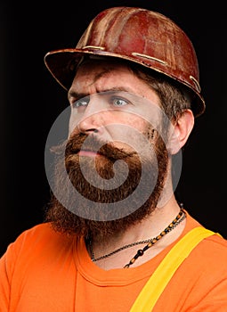 Industrial or mechanical worker in hard hat. Pensive bearded man in construction helmet. Profession, construction and