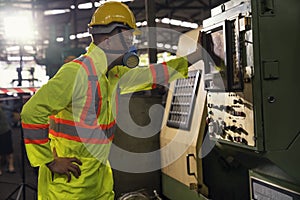 Industrial mechanics are working in front of a factory machine. Young technicians factory worker controlling the work