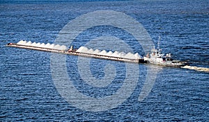 Industrial merchant seagoing vessel sails on small waves in  pre-storm weather.  ship with  cargo goes to  point of delivery of