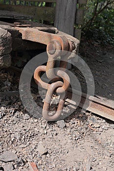 Industrial mine cart scene focusing on chain linkage