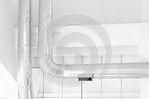 Interior in light tones: white walls and silver pipes
