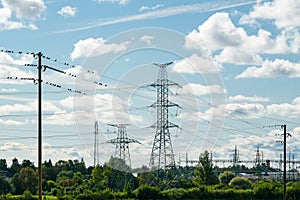 Industrial nature landscape with many high voltage power lines transmission pylons, birds on wires