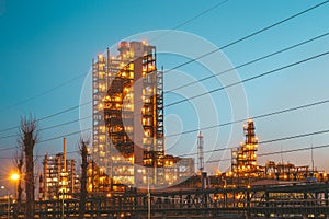 Industrial oil petrochemical refinery factory or plant with pipes and petroleum towers with night illumination