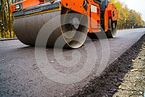 Industrial pavement truck. Laying fresh asphalt on construction site. Heavy machine industry. Mechanical engineering.