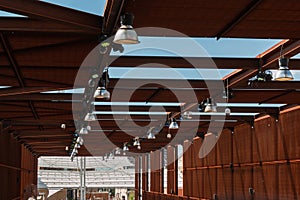 Industrial Pavilion: Wooden Roof Structure with Lamps and Cams