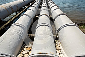 Industrial pipes near power station, feeding into the river. Environmental pollution concept.