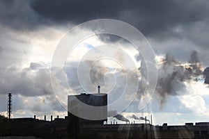 Industrial plant against cloudy sky