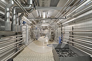 Industrial plant in a modern brewery - technology in a factory building with pipes and fittings