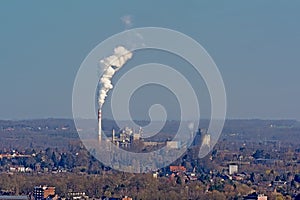 Industrial plant with smoking chimney near Mons photo