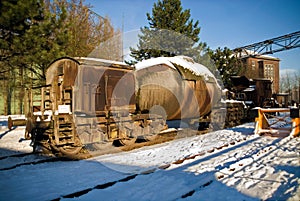 Industrial plant torpedo car train rail in winter snow ice steel