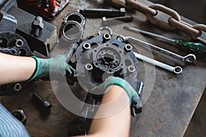 Industrial plant worker repairing car parts in auto repair workshop - Mechanical engineer inspecting and adjusting