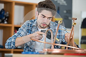 Industrial plumber using blowtorch