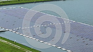 Industrial pond with floating photovoltaic solar panels for producing clean electrical energy. Concept of renewable