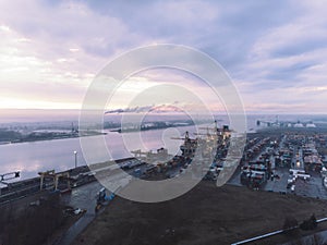 Industrial port with containers. Overhead drone footage of shipping containers with transport network trucks. Import, export