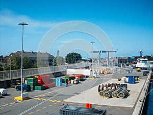 Industrial port with containers, trucks and ships at pier