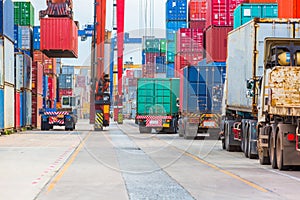 Industrial port crane lift up loading export containers box onboard.