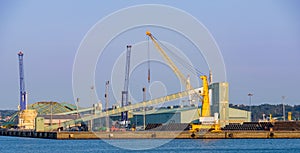 Industrial port facilities in Spain with heavy cranes a