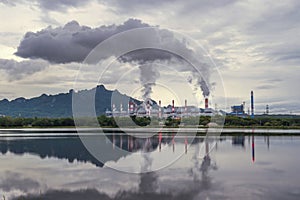 Industrial power plant with smokestack near the river