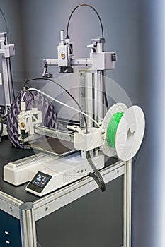 Industrial precision machine tool with gantry structure, engaged in cutting or engraving on a flat metalmaterial surface Gantry