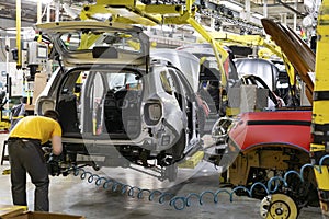 Industrial production of car automobiles. Plant for assembling modern cars on an assembly line. Industry, production