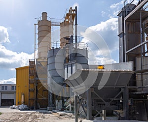 Industrial production of construction mixtures. Tower silos with bulk ingredients. Line for drying and sorting of sand