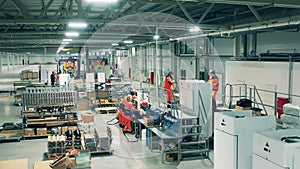 Industrial production factory interior. Refrigeration factory unit with manual assembly of fridges