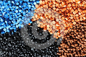 Industrial products of multi-coloured polymer granules. Multicolored mounds of plastic