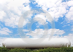 Industrial propane tank under blue sky