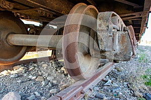 Industrial rail car wheels closeup photo. Old rusty train wheels. Wheel train system on track.