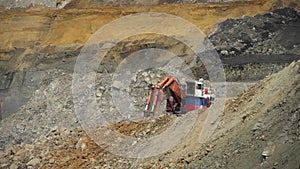 Industrial reportage. Large excavator digs in a coal mine