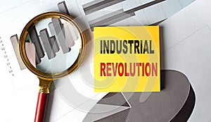 INDUSTRIAL REVOLUTION text on a sticky on chart, business