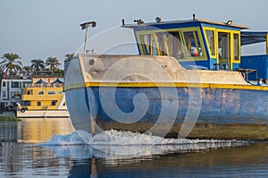 Industrial river barge traveling on river in Africa