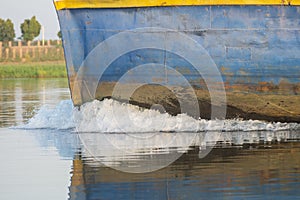 Industrial river barge traveling on river in Africa