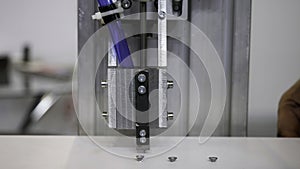 Industrial robot using automatic screwdriver on wooden product. Media. industrial machine at work at the construction