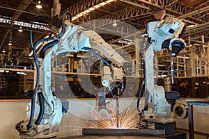 Industrial robot is welding assembly automotive part in factory photo