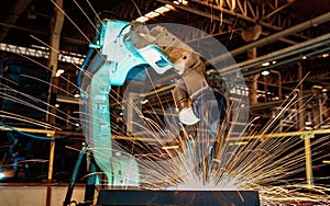 Industrial robot is welding in automotive part factory