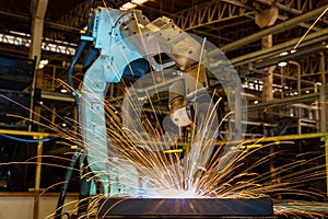 Industrial robot is welding in factory