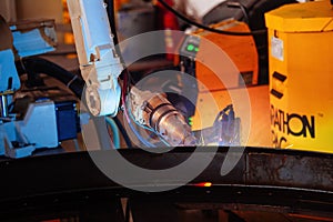 Industrial robot is welding metal machine part