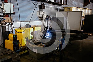 Industrial robot is welding metal machine part