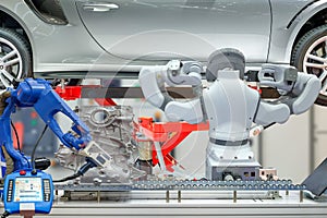 Industrial robotic teamwork working with auto parts for maintain car