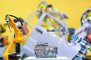 Industrial robotic welding and gripping robot working with metal part on blurred smart car factory background