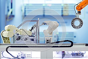 Industrial robotics teamwork working with auto parts parts on smart factory