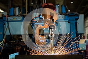 Industrial robots are welding assembly part in car factory photo