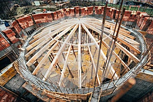 Industrial roof system of monastery building with wooden timber, beams and shingles. Architecture dome details at construction sit