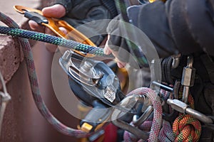 Industrial rope access worker hand connecting Nylon low stretch rope into descender