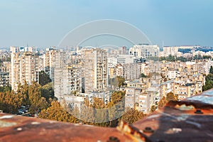 Industrial rope access worker hanging from the building while painting the exterior facade wall. Industrial alpinism concept image