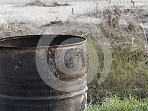 Industrial rusty metal barrel, environmental pollution, corrosion photo