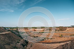 Industrial sand quarry with hydraulic excavator machinery. Beautiful industrial landscape, construction industry