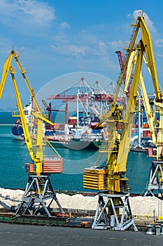 Industrial seaport infrastructure, sea, cranes and dry cargo ship, containers, concept of sea cargo transportation